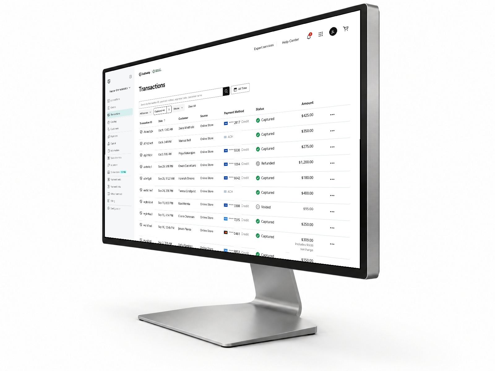 A GoDaddy transactions dashboard for a sample practice, shown on a desktop monitor